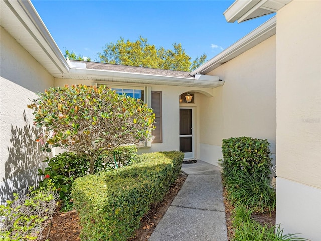doorway to property featuring stucco siding