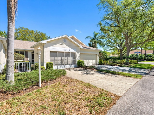 ranch-style house featuring a garage, roof with shingles, concrete driveway, and stucco siding
