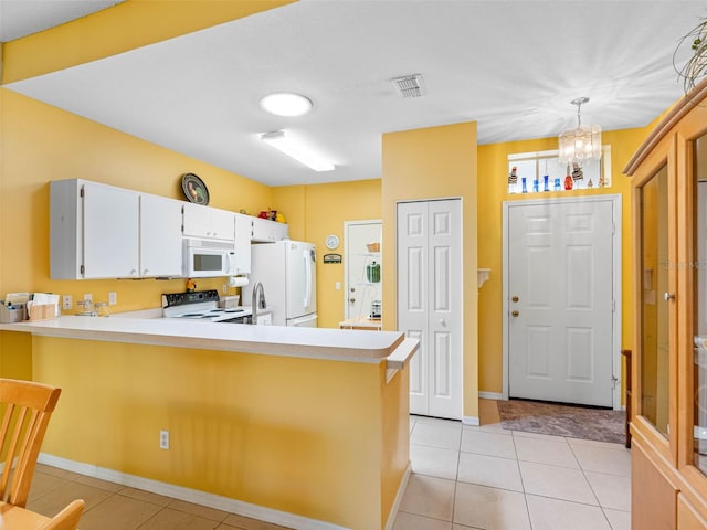 kitchen featuring an inviting chandelier, white appliances, light countertops, and a peninsula