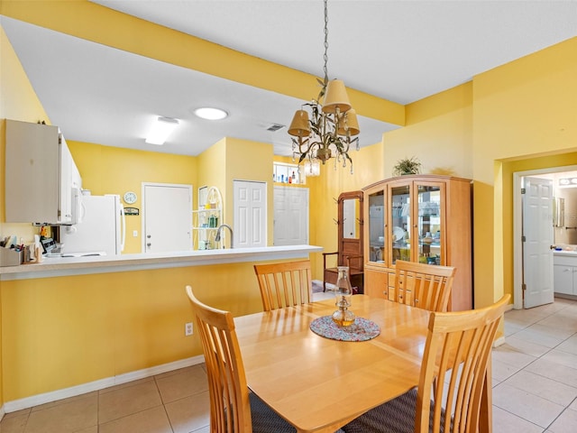 dining area with a notable chandelier, visible vents, baseboards, and light tile patterned floors