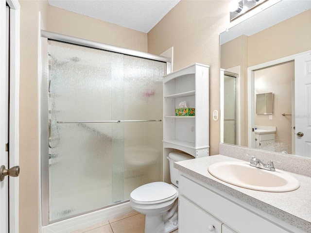 full bathroom with tile patterned floors, toilet, a stall shower, a textured ceiling, and vanity