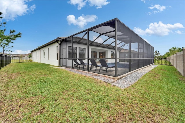 back of house with glass enclosure, a patio, a fenced backyard, stucco siding, and a lawn