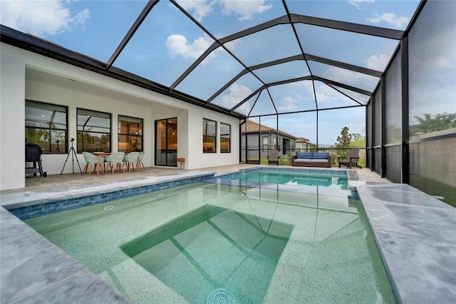 view of swimming pool featuring glass enclosure, a patio area, and a fenced in pool