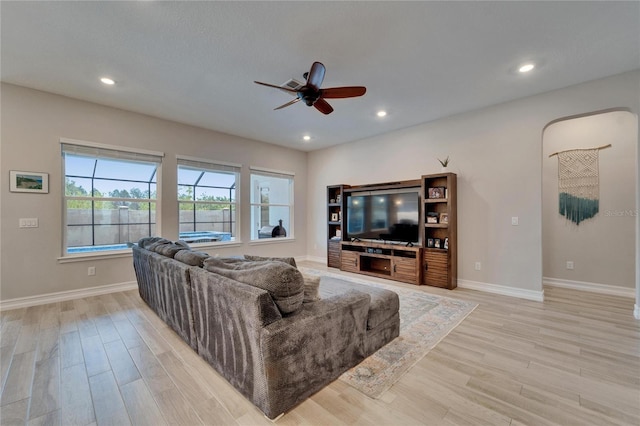 living area featuring recessed lighting, a ceiling fan, and light wood finished floors