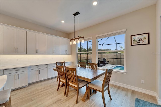 dining space with light wood-style flooring, recessed lighting, and baseboards