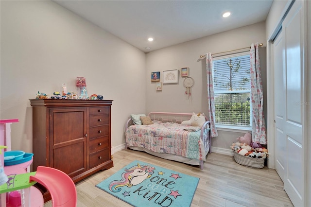 bedroom with recessed lighting, a closet, baseboards, and light wood-style floors