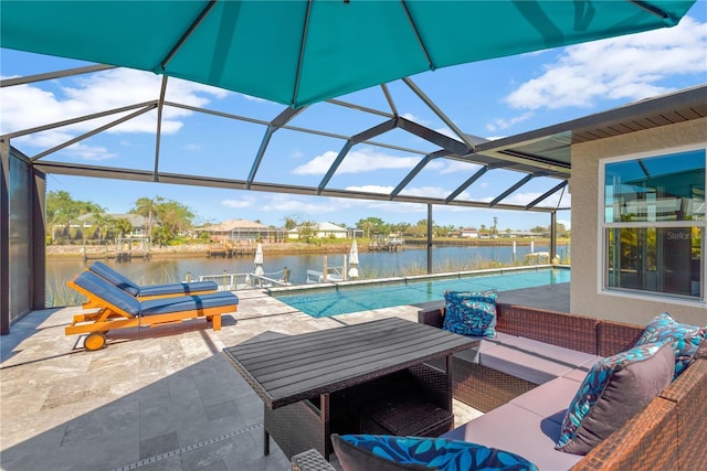 outdoor pool featuring outdoor lounge area, a patio area, and a water view