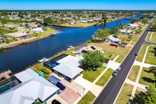 birds eye view of property with a water view and a residential view