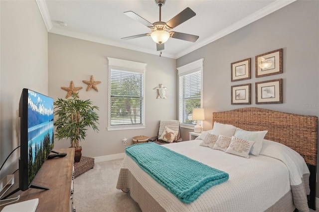 carpeted bedroom featuring baseboards, ornamental molding, and ceiling fan