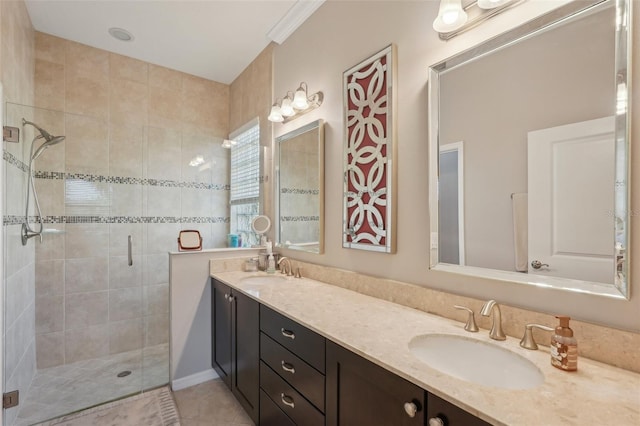 bathroom with double vanity, a sink, a stall shower, and tile patterned flooring