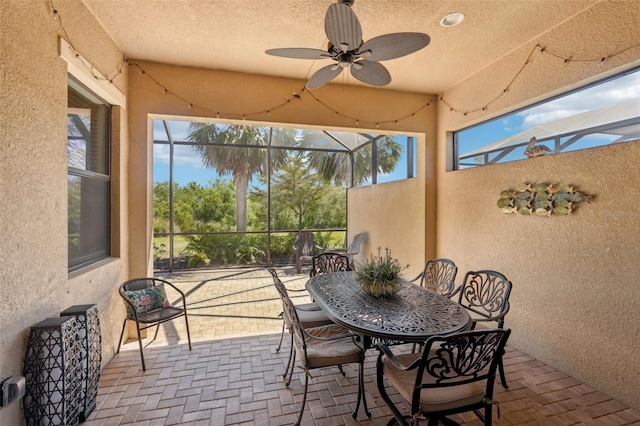 sunroom featuring ceiling fan