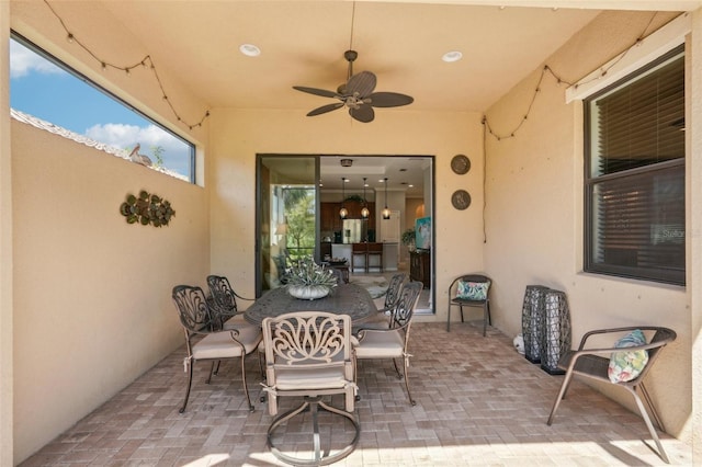 view of patio with outdoor dining area and ceiling fan