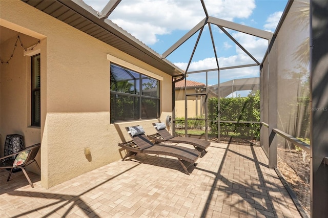 view of patio with glass enclosure