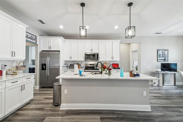 4307 Dristol Ave, Spring Hill, FL 34609 - kitchen with white cabinetry, dark wood-style flooring, decorative backsplash, visible vents, and appliances with stainless steel finishes