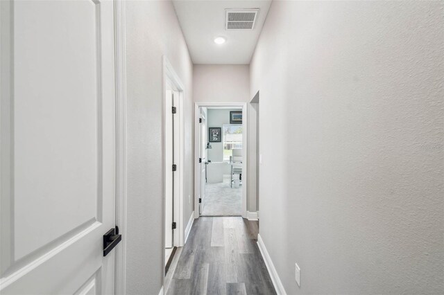 4307 Dristol Ave, Spring Hill, FL 34609 - hallway with baseboards, a textured wall, visible vents, and dark wood finished floors