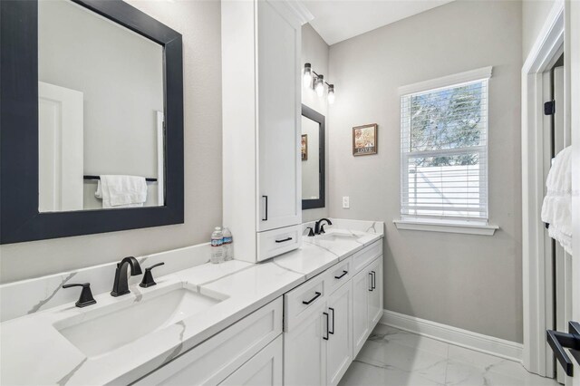 4307 Dristol Ave, Spring Hill, FL 34609 - bathroom with marble finish floor, baseboards, double vanity, and a sink