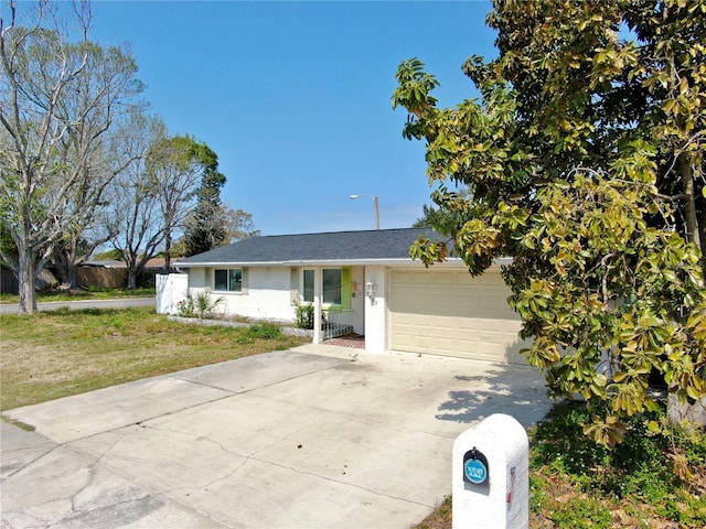 ranch-style house featuring fence, driveway, an attached garage, stucco siding, and a front lawn