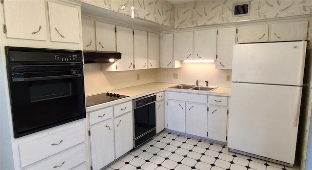 2402 Ecuadorian Way Unit 20, Clearwater, FL 33763 - kitchen with black appliances, a sink, under cabinet range hood, light floors, and light countertops