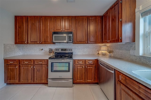 2700 Bayshore Blvd Unit 588, Dunedin, FL 34698 - kitchen with appliances with stainless steel finishes, light tile patterned floors, and light countertops