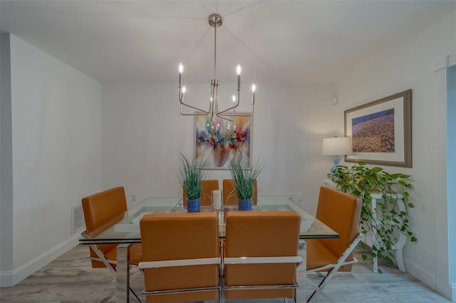 2700 Bayshore Blvd Unit 588, Dunedin, FL 34698 - dining room with a chandelier and baseboards