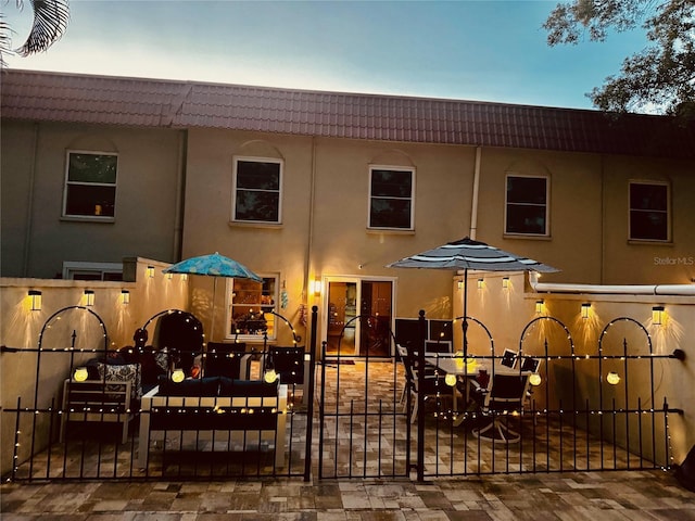 2700 Bayshore Blvd Unit 588, Dunedin, FL 34698 - back of house with a tiled roof, stucco siding, and a gate
