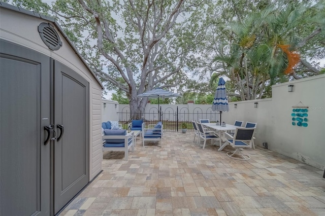 2700 Bayshore Blvd Unit 588, Dunedin, FL 34698 - fenced backyard with outdoor dining space, a patio area, a shed, and an outdoor living space