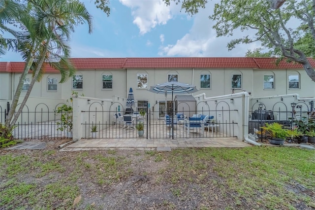 2700 Bayshore Blvd Unit 588, Dunedin, FL 34698 - back of property with a tile roof, a gate, and stucco siding