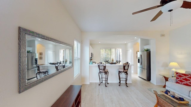 11822 Crawford Parrish Ln, Parrish, FL 34219 - kitchen featuring stainless steel fridge, arched walkways, light wood-style flooring, a ceiling fan, and recessed lighting
