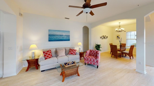 11822 Crawford Parrish Ln, Parrish, FL 34219 - living area featuring arched walkways, light wood-style flooring, ceiling fan, and a chandelier