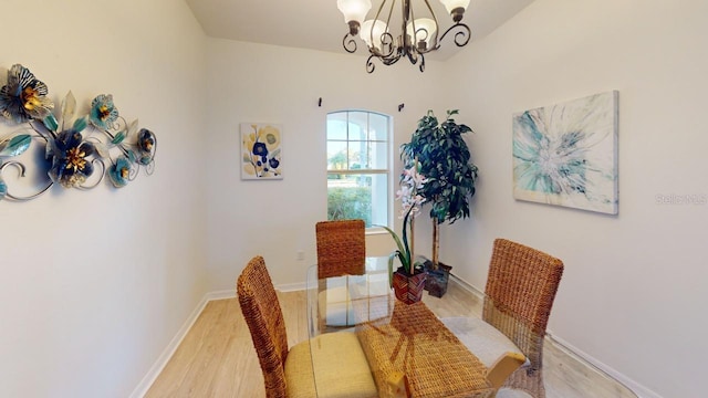 11822 Crawford Parrish Ln, Parrish, FL 34219 - dining area featuring a chandelier, light wood-type flooring, and baseboards