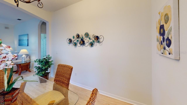 11822 Crawford Parrish Ln, Parrish, FL 34219 - dining room with arched walkways, light wood-type flooring, and baseboards