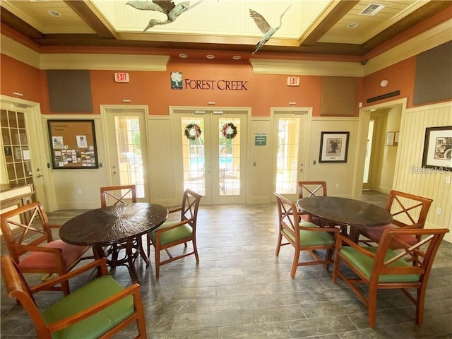 11822 Crawford Parrish Ln, Parrish, FL 34219 - dining room featuring a towering ceiling, french doors, a decorative wall, and crown molding