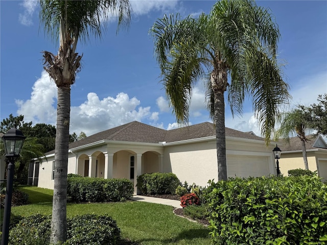 11822 Crawford Parrish Ln, Parrish, FL 34219 - view of side of home featuring an attached garage, a lawn, and stucco siding