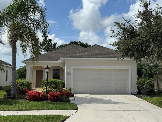11822 Crawford Parrish Ln, Parrish, FL 34219 - ranch-style house featuring driveway, a shingled roof, a garage, and stucco siding