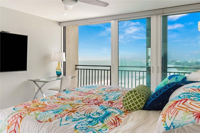 bedroom with access to outside, a water view, and a ceiling fan