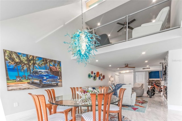 dining area with ceiling fan, a high ceiling, recessed lighting, marble finish floors, and baseboards