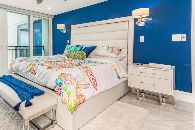 bedroom with access to exterior and marble tiled flooring