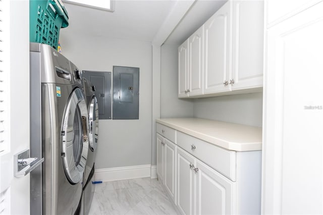 washroom featuring washer and dryer, cabinet space, light marble finish floors, and electric panel