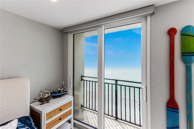 bedroom featuring a water view and multiple windows