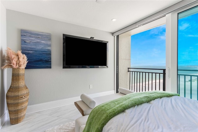 bedroom with baseboards, access to outside, and marble look tile flooring
