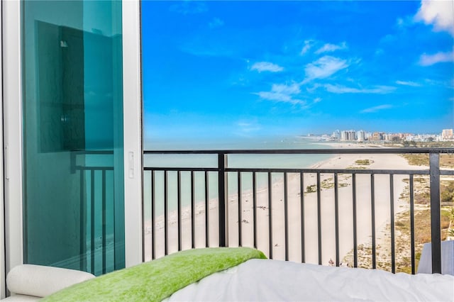 balcony with view of water and beach