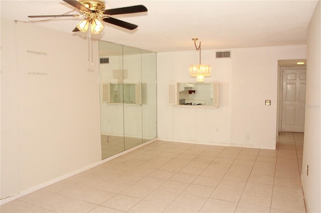 19029 US Highway 19 N Unit 2-12, Clearwater, FL 33764 - spare room featuring ceiling fan, light tile patterned floors, a chandelier, and baseboards
