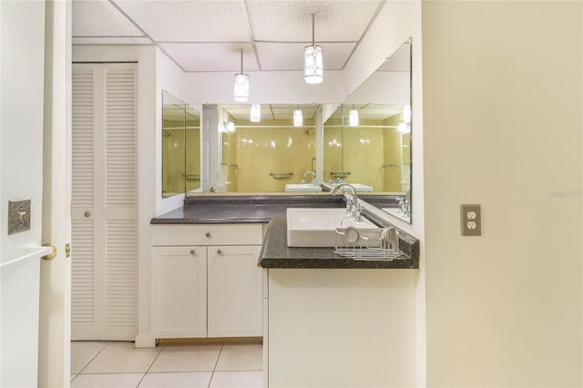 19029 US Highway 19 N Unit 2-12, Clearwater, FL 33764 - bathroom with a closet, a drop ceiling, tile patterned floors, double vanity, and a shower stall