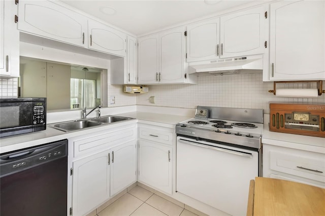 19029 US Highway 19 N Unit 2-12, Clearwater, FL 33764 - kitchen with black appliances, under cabinet range hood, a sink, light countertops, and white cabinetry