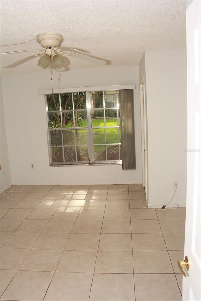19029 US Highway 19 N Unit 2-12, Clearwater, FL 33764 - unfurnished room with a ceiling fan, light tile patterned floors, and a textured ceiling