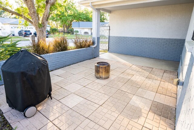view of patio / terrace with grilling area and a gate