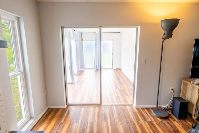 unfurnished room featuring baseboards and wood finished floors