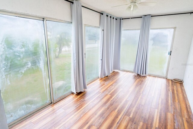 unfurnished sunroom featuring wood finished floors