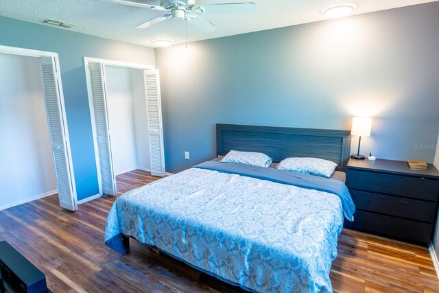 bedroom featuring wood finished floors, baseboards, and a textured ceiling