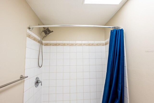 bathroom with tiled shower